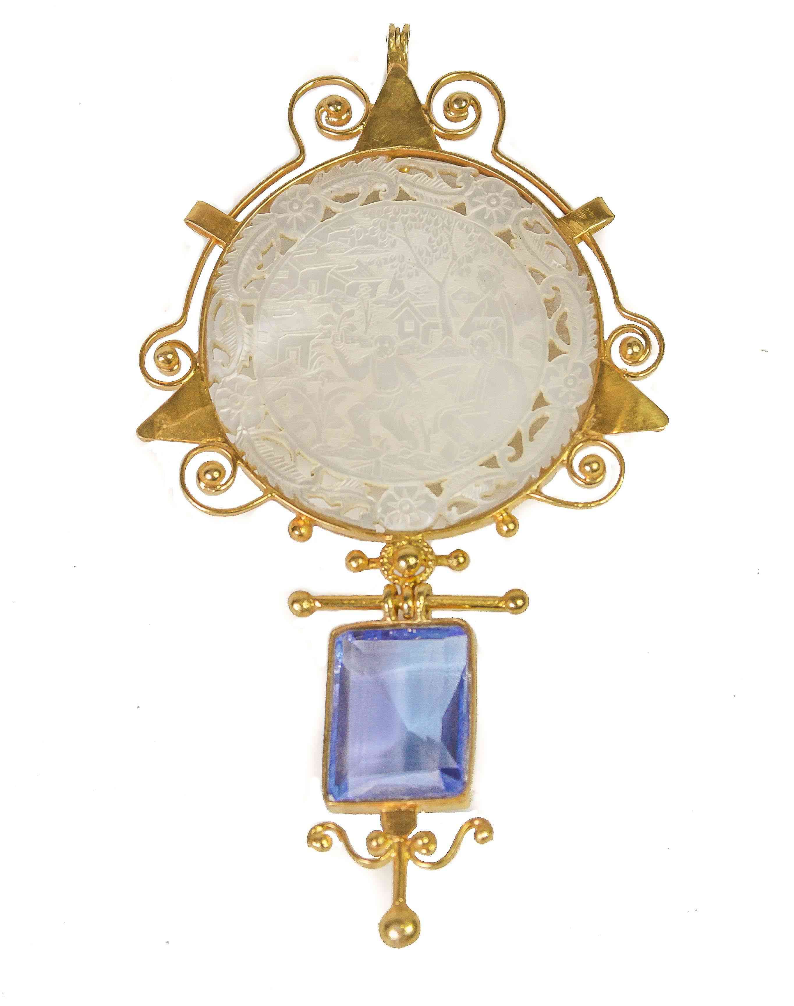 A Mother Of Pearl Gaming Chip Pendant With Blue Topaz