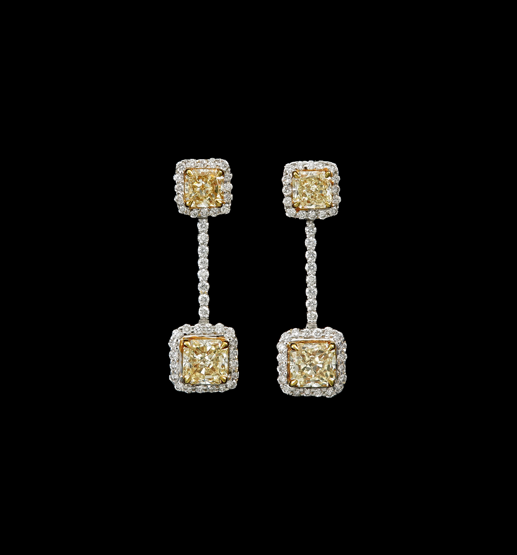  A pair of barbellshaped drop earrings with 2.45 tcw yellow tinged