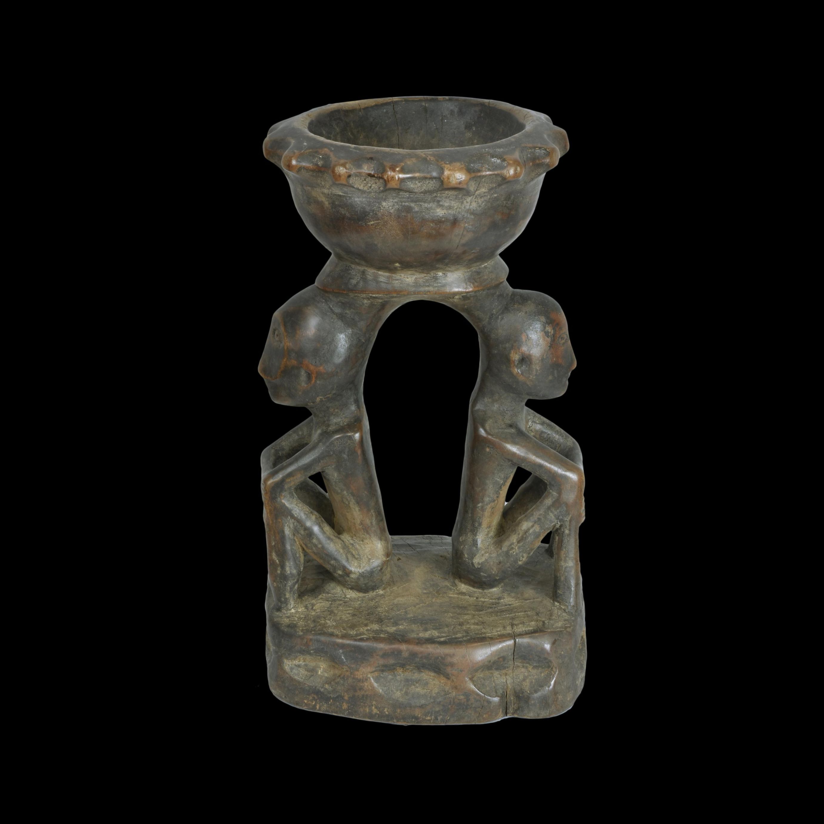 - A double seated figure with small duyo on top of head